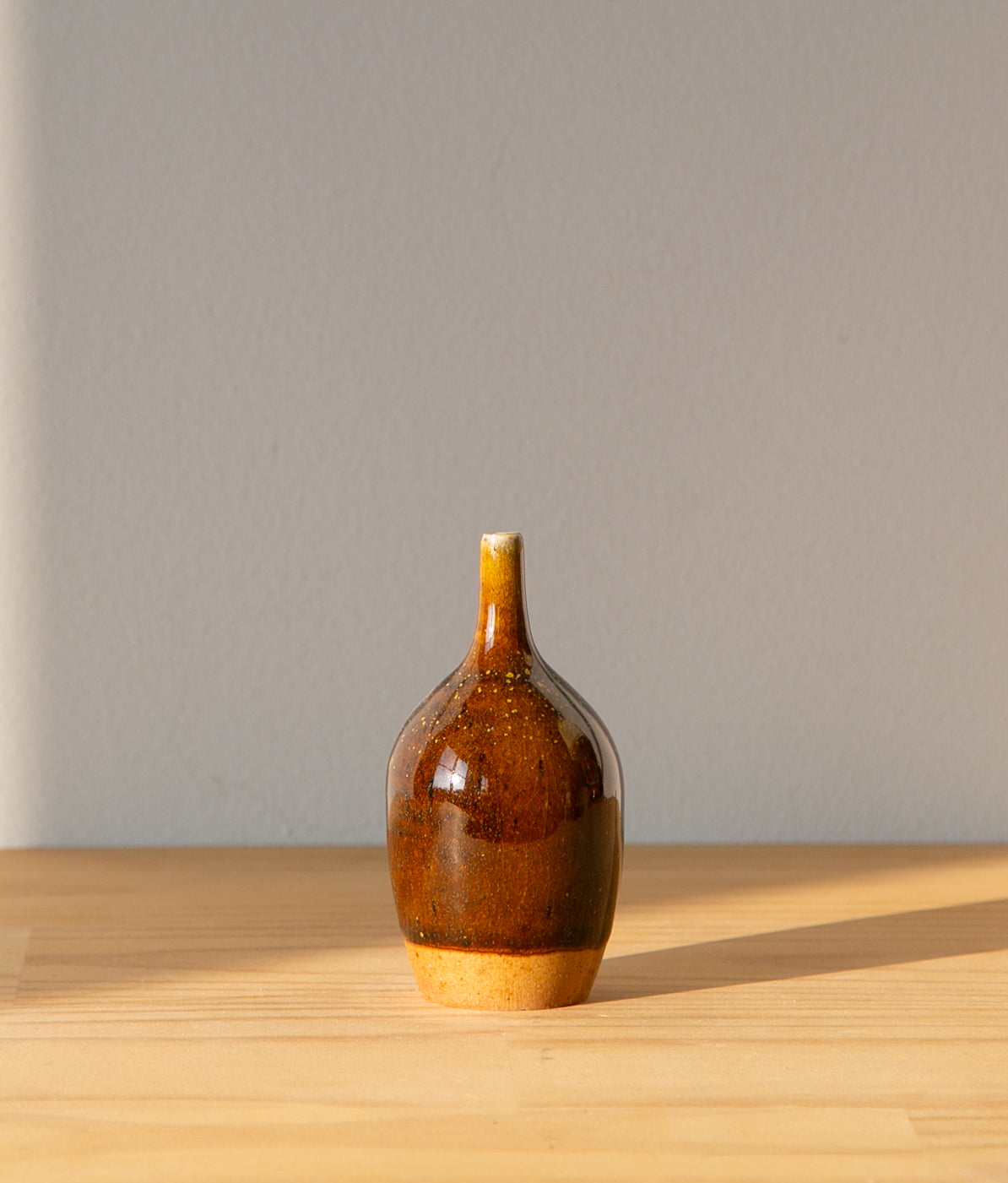 Pollen-flecked brown bud vase