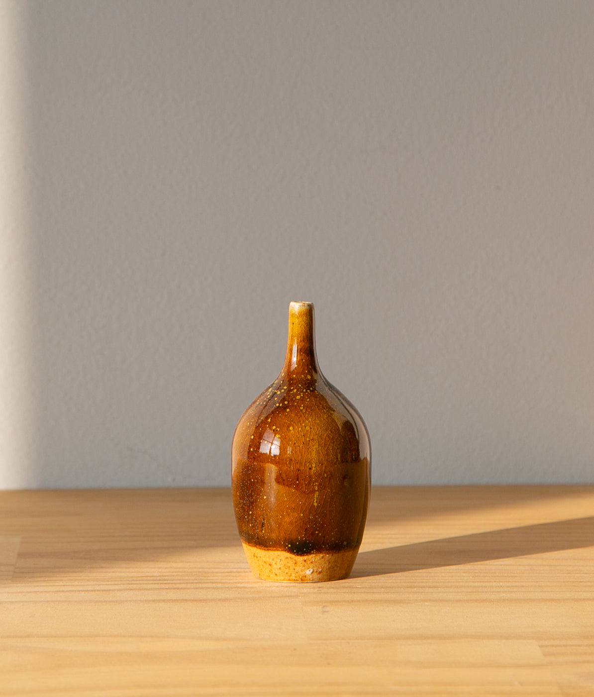Pollen-flecked brown bud vase