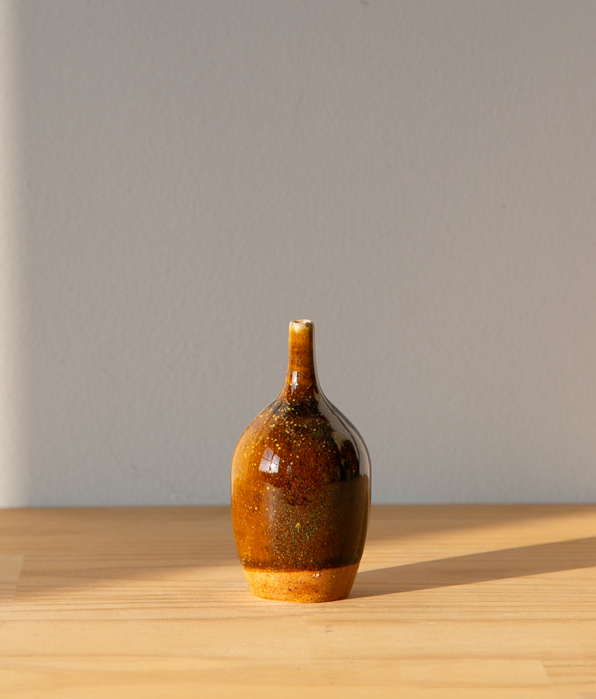 Pollen-flecked brown bud vase